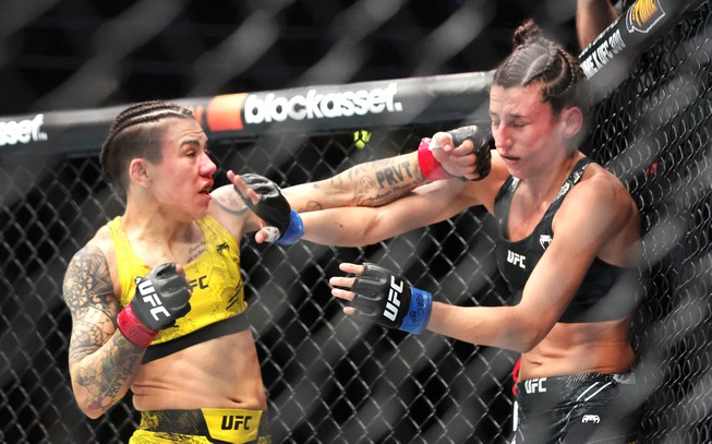 Jessica Andrade, left, punches Marina Rodriguez in a women’s strawweight bout during UFC 300 at T-Mobile Arena Saturday, April 13, 2024, in Las Vegas. Andrade won the bout by split decision.