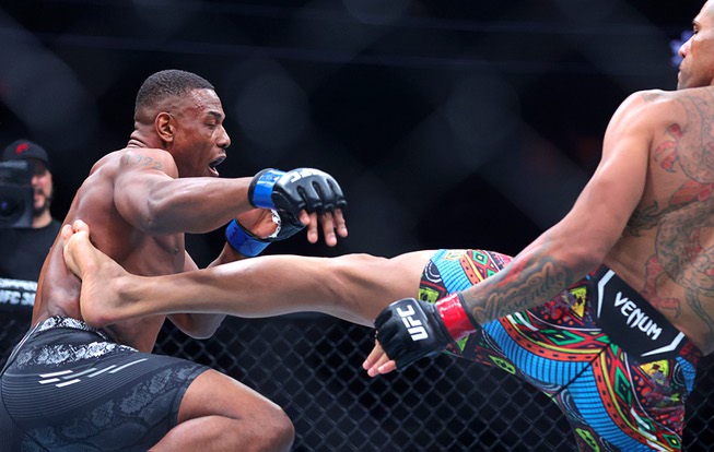 Jamahal Hill gets hit with a kick from UFC light heavyweight champion Alex Pereira during UFC 300 at T-Mobile Arena Saturday, April 13, 2024, in Las Vegas.