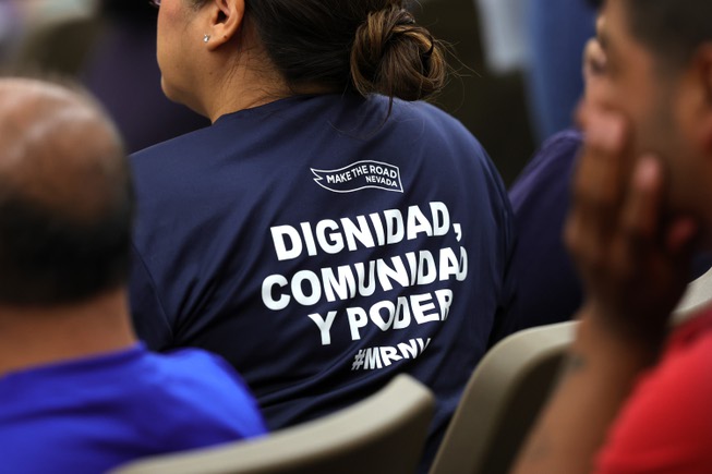 A woman wears a shirt that reads (in English) “community dignity and power” during a Clark County meeting on a street vendor ordinance at the Clark County Government Center Tuesday, April 16, 2024.