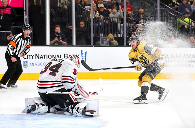 Chicago Blackhawks goaltender Petr Mrazek (34) makes a save against Vegas Golden Knights right wing Jonathan Marchessault (81) during the first period of an NHL hockey game at T-Mobile Arena Tuesday, April 16, 2024.