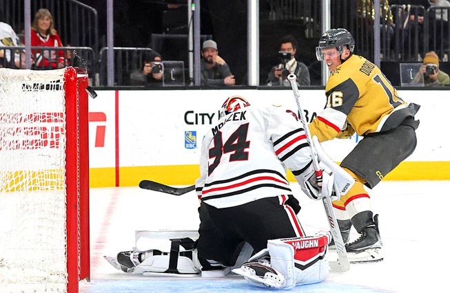 A puck shot by Vegas Golden Knights left wing Pavel Dorofeyev (16) bounces off the crossbar as Chicago Blackhawks goaltender Petr Mrazek (34) defends during the third period of an NHL hockey game at T-Mobile Arena Tuesday, April 16, 2024.