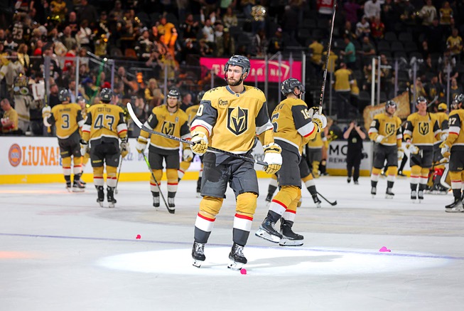 Vegas Golden Knights center Nicolas Roy, center, and other Vegas Golden Knights players celebrate after defeating the Chicago Blackhawks, 3-1, in an NHL hockey game at T-Mobile Arena Tuesday, April 16, 2024.