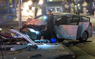 A Metro Police crime scene analyst takes photos at a fatal accident scene on southbound Boulder Highway Wednesday, April 17, 2024. An adult and child were killed and three others were injured, police said.