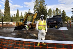 Environmental cleanup specialists work at one of the last remaining residential asbestos cleanup sites in Libby, Montana, in mid-September. BNSF Railway attorneys are expected to argue before jurors Friday, April 19, 2024, that the railroad should not be held liable for the lung cancer deaths of two former residents of the asbestos-contaminated Montana town, one of the deadliest sites in the federal Superfund pollution program. 