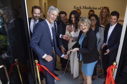 Keck Hospital of USC’s Chief of Operations Jon Reuter, front left, and Transplant Administrator Pat Stricklin, front right, cut a ribbon during the opening of Keck Medicine of USC’s new liver and heart transplant treatment center Thursday, April 25, 2024.