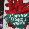 A woman holds a banner reading in Spanish, "Legal, safe, and free abortion" as abortion rights protesters demonstrate in front of the National Congress on the "Day for Decriminalization of Abortion in Latin America and the Caribbean," in Mexico City, Sept. 28, 2020. 