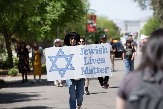 A women holds a sign showing her support for Israel during a pro Palestine rally on UNLV’s campus Wed. May 1, 2024.