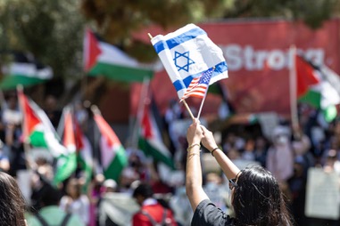 Veronica Gelfman waves Israeli and American flags to counterprotest a pro-Palestinian rally on UNLV’s campus Wednesday, May 1, 2024.