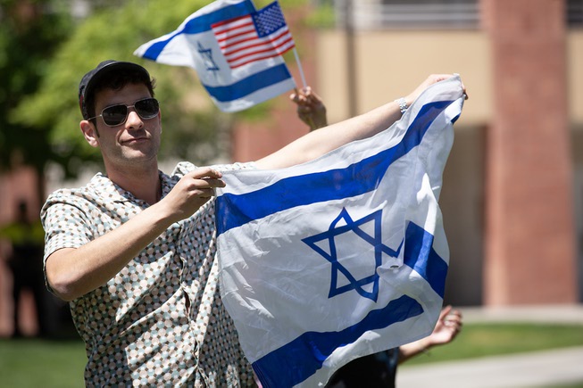 An Israeli supporter holds an Israeli flag during a pro Palestine rally on UNLV’s campus Wed. May 1, 2024.