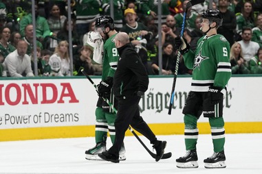 Dallas Stars’ Tyler Seguin, left, is escorted off the ice by a staff member and Nils Lundkvist, after taking a hit to the face by Vegas Golden Knights’ Alex Pietrangelo in the second period in Game 5 of an NHL hockey Stanley Cup first-round playoff series in Dallas, Wednesday, May 1, 2024. Pietrangelo recieved a penalty on the play. 