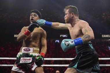 Canelo Alvarez hits Jaime Munguia in a super middleweight title fight Saturday, May 4, 2024, in Las Vegas.