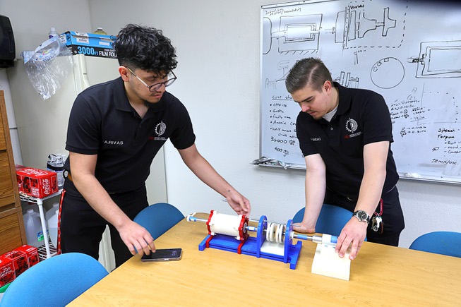 UNLV mechanical engineering students Adrian Rivas, left, and Gustavo Moreno are shown by their team’s proof of concept model at UNLV Wednesday, May 8, 2024. The team’s project, “Development of a Magnetic Coupler and Gear Drive,” won the grand prize and sustainability prize at the biannual Senior Design Competition.