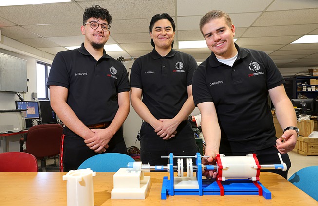 UNLV mechanical engineering students, from left, Adrian Rivas, Carlos Miguel Herranz and Gustavo Moreno, pose in front of a proof of concept model at UNLV Wednesday, May 8, 2024. (not pictured is team member Rafael Joseph Llamzon). The team’s project, “Development of a Magnetic Coupler and Gear Drive,” won the grand prize and sustainability prize at the biannual Senior Design Competition.