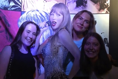 In this image taken from video, fans pose with a life-size image of Taylor Swift at a club that plays only Swift's music in Gothenburg, Sweden, on Tuesday, April 30th, 2024.