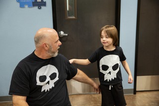 Shaun Wilson and his 6-year-old son Christopher share a moment during a behavioral treatment session at the Touro University Pierce Autism Center Thursday May 9, 2024.