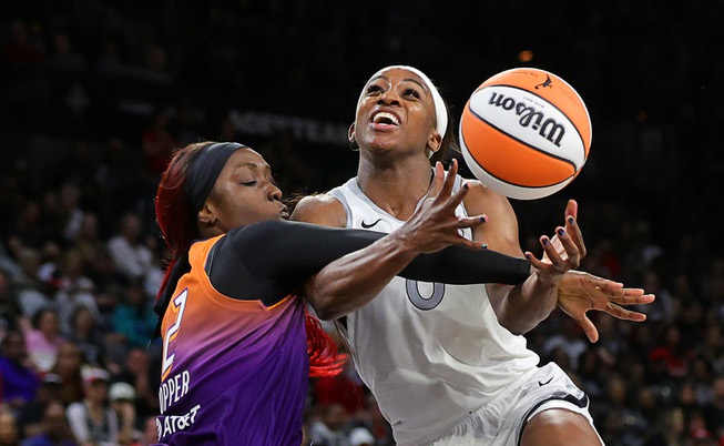 Las Vegas Aces guard Jackie Young (0) is fouled by Phoenix Mercury guard Kahleah Copper (2) during the second half of an WNBA basketball game at Michelob Ultra Arena in Mandalay Bay Tuesday, May 14, 2024.