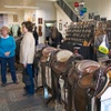 Visitors mingle at the Cowboy Arts & Gear Museum, where renowned saddle maker Guadalupe Santiago Garcia’s works are on display. Garcia, who lived from 1864 to 1933, opened his G.S. Garcia Saddle & Harness Shop in the building in 1913.