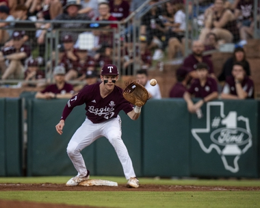 Texas A&M infielder Ted Burton (27) makes a catch at first for out in game two of the series between Arkansas and Texas A&M on Friday, May 17, 2024 at Blue Bell Park in College Station. (Meredith Seaver/College Station Eagle via AP)