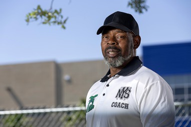 Coach Kevin Walker poses by Katz Elementary School Wednesday, June 12, 2024. Walker used to run a youth football camp at the school from 2010-2018, he said.
