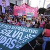 Abortion rights activists march against an anti-abortion congressional bill, along Paulista Avenue in Sao Paulo, Saturday, June 15, 2024. 