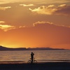 A man on a bike photographs the sunset at the Great Salt Lake Thursday June 13, 2024, near Salt Lake City. 