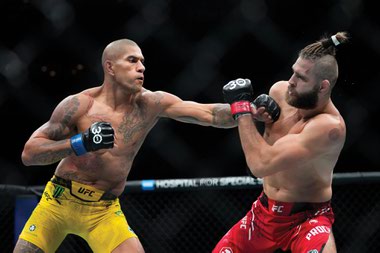 Alex Pereira, left, punches Jiří Procházka during the second round of a light heavyweight title bout at UFC 295 on November 12, 2023, in New York.