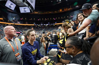 Indiana Fever guard Caitlin Clark signs autographs for fans before an WNBA basketball game between the Las Vegas Aces and the Indiana Fever at T-Mobile Arena Tuesday, July 2, 2024.