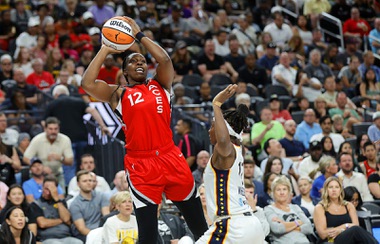 Las Vegas Aces guard Chelsea Gray (12) shoots as Indiana Fever guard Erica Wheeler (17) defends during the first half of an WNBA basketball game at T-Mobile Arena Tuesday, July 2, 2024.