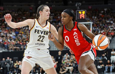 Indiana Fever guard Caitlin Clark (22) defends against Las Vegas Aces guard Jackie Young (0) during the first half of an WNBA basketball game at T-Mobile Arena Tuesday, July 2, 2024.