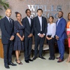 Students and officials pose in the lobby of the Wells Fargo Bank tower Tuesday, July 2, 2024. From left are: Wendell Blaylock, public affairs for Wells Fargo Nevada and Utah, Fineza Tangua, diverse segment leader for Wells Fargo Western Division, Pharaoh Washington, Ross Graydon, Keilana Stephenson, Kirk Richards, instructor for the 100 Black Men of Las Vegas Junior Investor Club, and Rhonda Nolen, program manager for 100 Black Men of Las Vegas.