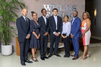 Students and officials pose in the lobby of the Wells Fargo Bank tower Tuesday, July 2, 2024. From left are: Wendell Blaylock, public affairs for Wells Fargo Nevada and Utah, Fineza Tangua, diverse segment leader for Wells Fargo Western Division, Pharaoh Washington, Ross Graydon, Keilana Stephenson, Kirk Richards, instructor for the 100 Black Men of Las Vegas Junior Investor Club, and Rhonda Nolen, program manager for 100 Black Men of Las Vegas.