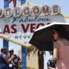 Photo: A person uses an umbrella to block the sun while w