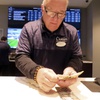 A worker at the sports book in the Ocean Casino Resort counts money on Feb. 6, 2023, in Atlantic City, N.J.