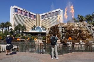 Tourists take video of the final “volcano eruption” show in front of the Mirage hotel-casino before the casino was closed Wednesday, July 17, 2024.