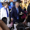 President Joe Biden and Maritza Rodriguez, Biden for President Latina adviser, greets patrons at Lindo Michoacan Mexican Restaurant, during a stop in Las Vegas, Wednesday, July 17, 2024.
