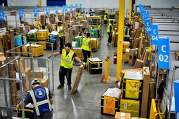 Amazon employees load packages on carts before being put on to trucks for distribution for Amazon's annual Prime Day event at an Amazon's DAX7 delivery station on Tuesday, July 16, 2024, in South Gate, Calif. 


