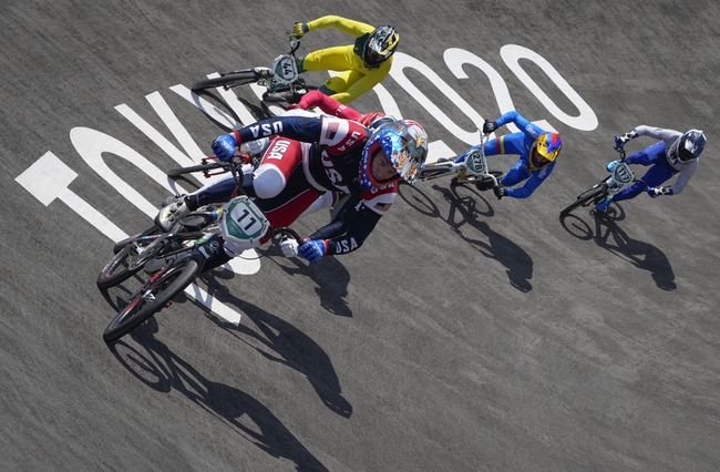 Connor Fields of the United States, center, leads with Anthony Dean of Australia, above, Carlos Alberto Ramirez Yepes of Colombia, 2nd right, and Giacomo Fantoni of Italy, right, following, in the men's BMX Racing quarterfinals at the 2020 Summer Olympics, Thursday, July 29, 2021, in Tokyo, Japan.