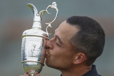 Xander Schauffele of the United States kisses the Claret Jug trophy after winning the British Open Golf Championships at Royal Troon golf club in Troon, Scotland, Sunday, July 21, 2024.