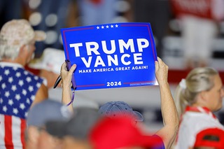 A supporter of former President Donald Trump holds up a Trump-Vance sign during a campaign rally featuring Republican vice presidential candidate Sen. JD Vance, R-Ohio, at Liberty High School in Henderson Tuesday, July 30, 2024.