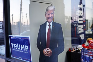 A cardboard cutout of former president and current Republican presidential candidate Donald Trump appears to look out from a window at the Mesquite Republican Women’s club in Mesquite, Nev. Wednesday, July 31, 2024.