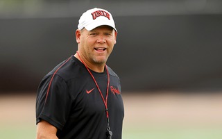 UNLV Football head coach Barry Odom watches players warm up during football practice at the Fertitta Football complex Friday, Aug. 2, 2024.