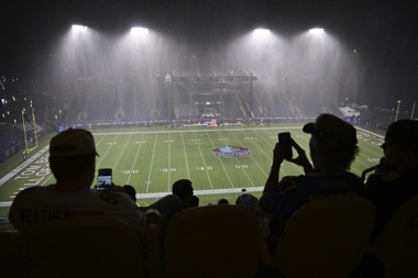 Football fans watch rain fall at Tom Benson Hall of Fame Stadium which forced the cancellation of an NFL exhibition Hall of Fame football game between the Chicago Bears and the Houston Texans during the third quarter, Thursday, Aug. 1, 2024, in Canton, Ohio.