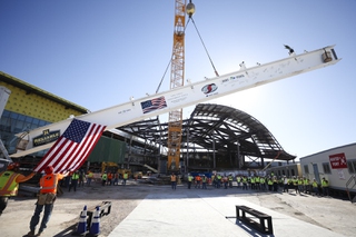 Workers guide the final piece of structural steel in the $600 million renovation of the Las Vegas Convention Center’s (LVCC) legacy campus as it is raised during a topping out ceremony Tuesday, Aug. 13, 2024. WADE VANDERVORT