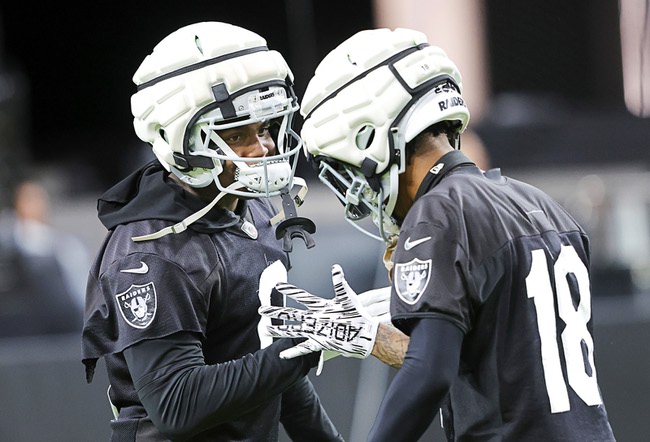 Las Vegas Raiders cornerback Jakorian Bennett (0) and cornerback Jack Jones (18) greet each other during a training camp open practice at Allegiant Stadium Tuesday, Aug. 20, 2024.