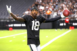 Las Vegas Raiders cornerback Jack Jones (18) interacts with fans during a training camp open practice at Allegiant Stadium Wednesday, Aug. 14, 2024.