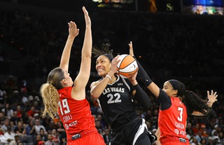 Las Vegas Aces center A'ja Wilson (22) prepares to shoot between Atlanta Dream forward Lorela Cubaj (19) and guard Jordin Canada (3) during the first half of an WNBA basketball game Friday, Aug. 30, 2024.