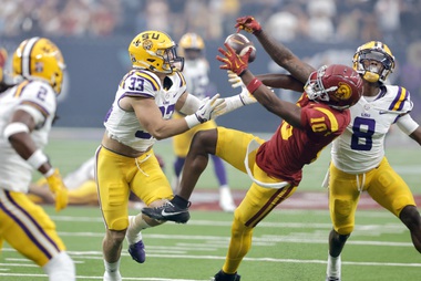 Southern California wide receiver Kyron Hudson (10) pulls in a pass between LSU linebacker West Weeks (33) and safety Major Burns (8) during the first half of an NCAA college football game Sunday, Sept. 1, 2024, in Las Vegas.