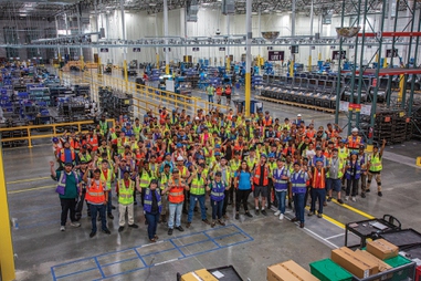 Workers pose at the new Aristocrat Gaming facility.
