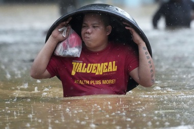 A resident uses a laundry tub to protect him from rain as he wades along a flooded street caused by Tropical Storm Yagi, locally called Enteng, on Monday, Sept. 2, 2024, in Cainta, Rizal province, Philippines.


