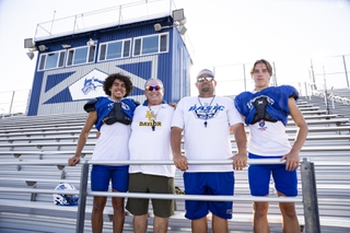 The Cahill family, from left, Louden Cahill, 16, assistant head coach Dan Cahill, head coach Jeff Cahill and Madden Spielberg, 16, pose for a photo at Basic Academy in Henderson Wednesday, Sept. 4, 2024.